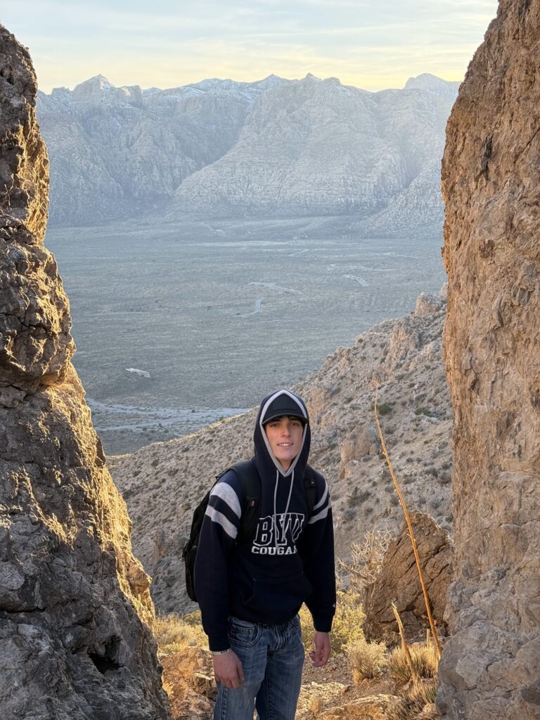 Elias Bartu standing among rock spires on a mountain hike near Las Vegas